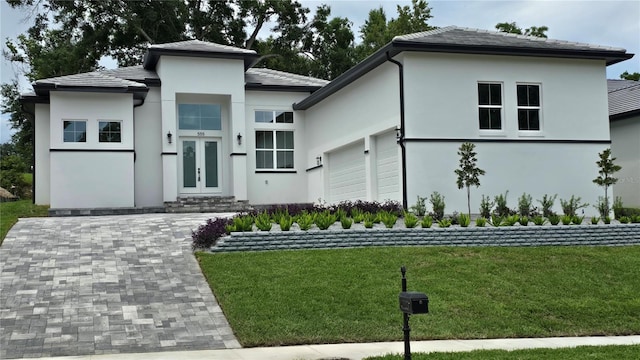 view of front of property featuring a garage and a front yard