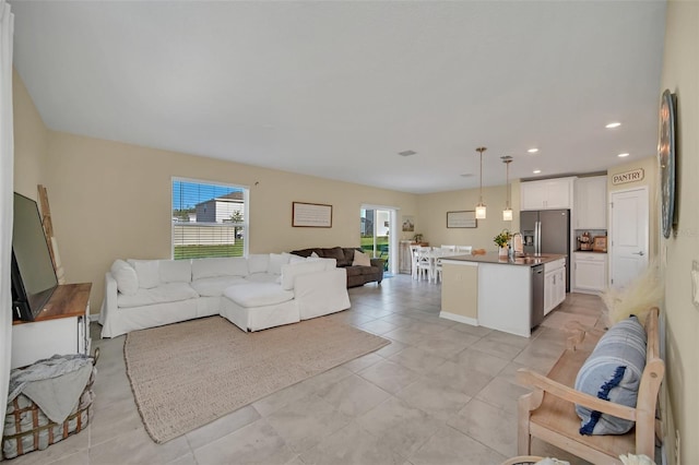 living room featuring sink and light tile floors