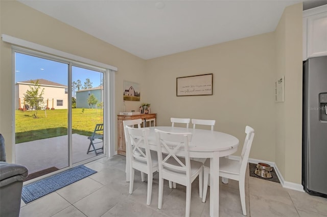 dining area featuring light tile floors