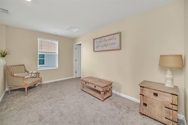 sitting room featuring carpet flooring