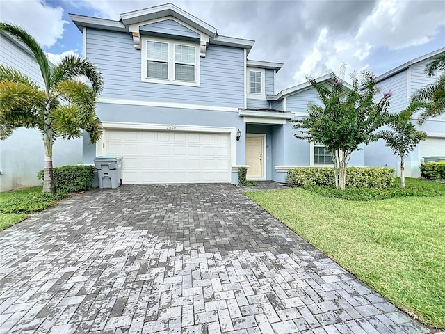 view of front facade with a front lawn and a garage