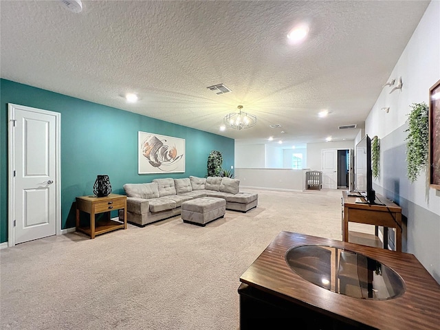 living room featuring light carpet, a textured ceiling, and an inviting chandelier