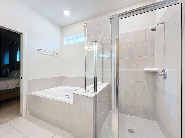 bathroom featuring tile patterned flooring and shower with separate bathtub