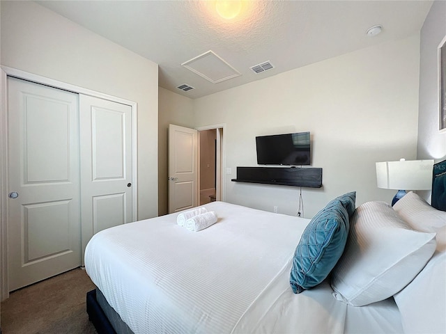 carpeted bedroom featuring a closet and a textured ceiling