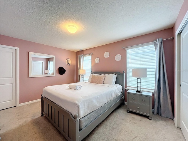 carpeted bedroom featuring a textured ceiling