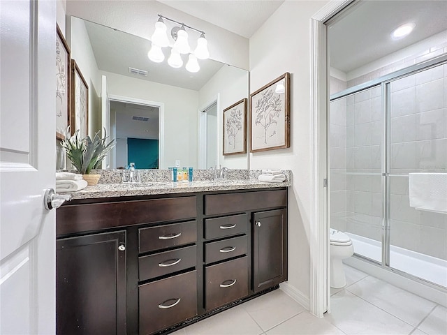 bathroom with tile patterned flooring, vanity, toilet, and walk in shower