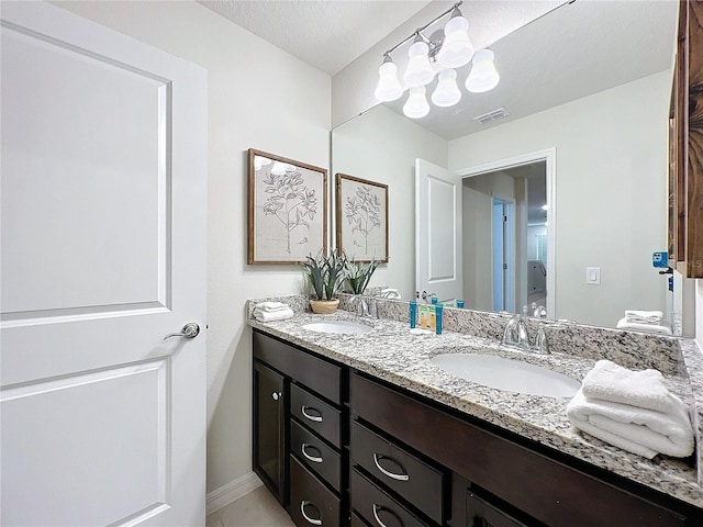 bathroom featuring vanity and a textured ceiling