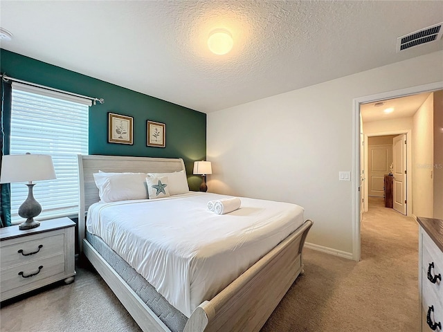 carpeted bedroom with a textured ceiling