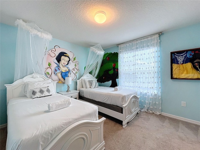 bedroom with light colored carpet and a textured ceiling