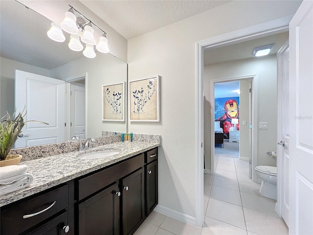 bathroom with tile patterned floors, vanity, toilet, and a textured ceiling