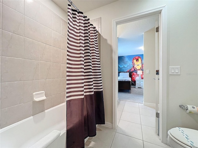 bathroom featuring tile patterned flooring, shower / bath combo, and toilet