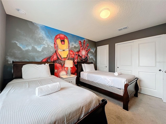 carpeted bedroom featuring a textured ceiling