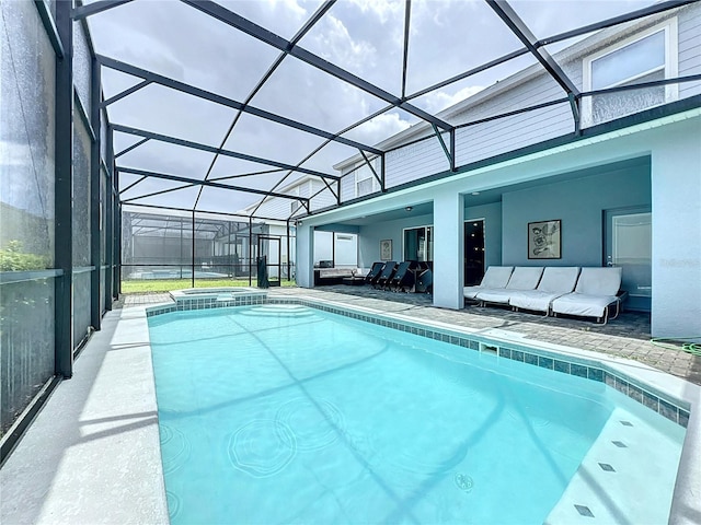 view of swimming pool with glass enclosure and a patio