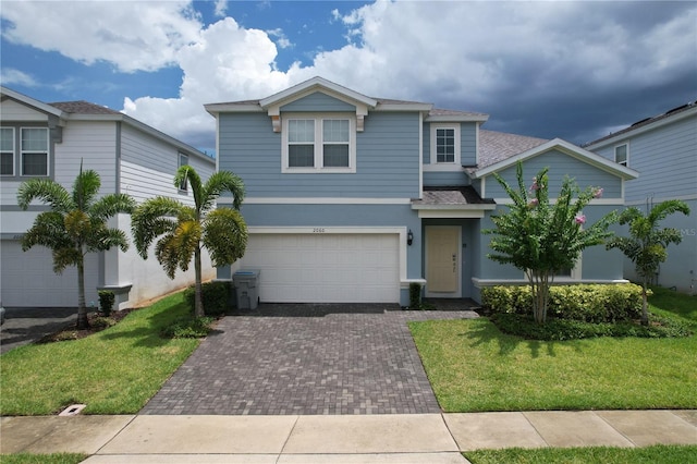 view of front facade with a front lawn and a garage