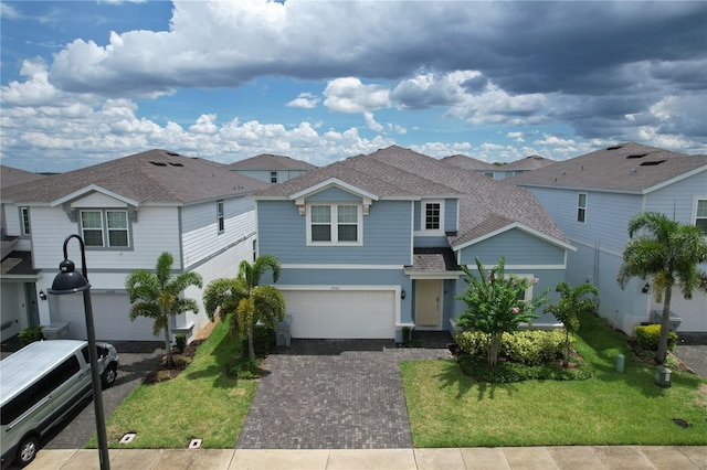 view of front of property featuring a front yard and a garage