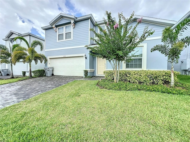 view of front of house featuring a garage and a front lawn