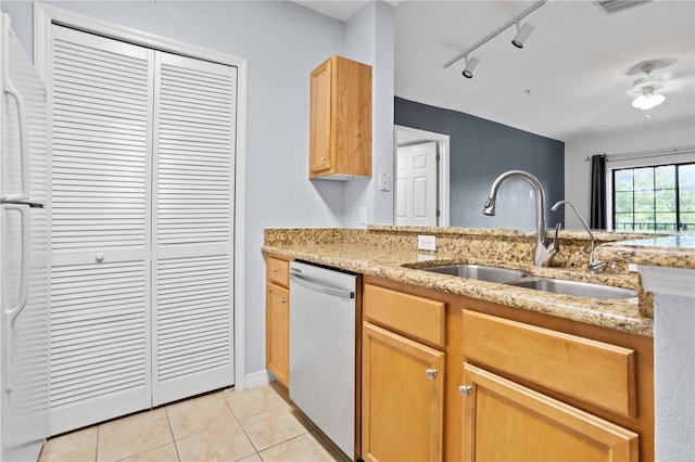 kitchen featuring track lighting, sink, light tile patterned floors, dishwasher, and white fridge