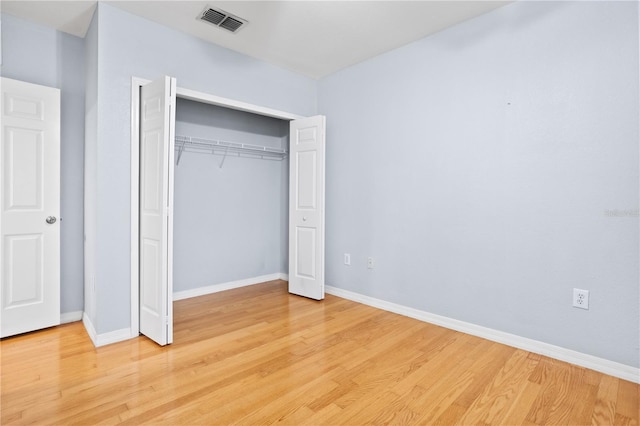 unfurnished bedroom featuring a closet and light hardwood / wood-style flooring