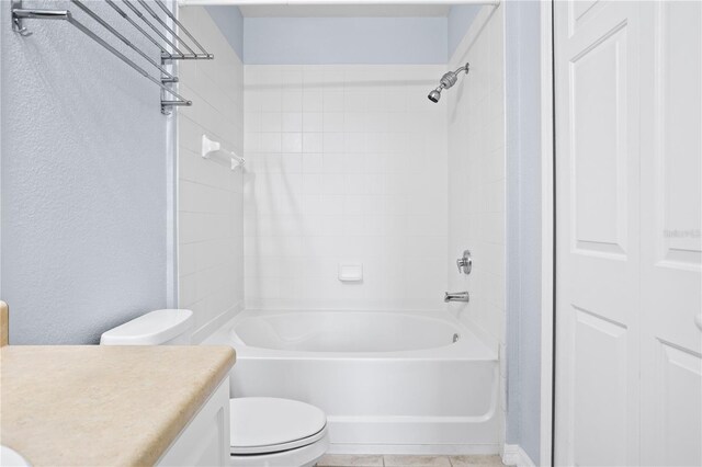 full bathroom featuring washtub / shower combination, tile patterned floors, vanity, and toilet