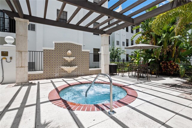 view of pool with a pergola, a community hot tub, and a patio