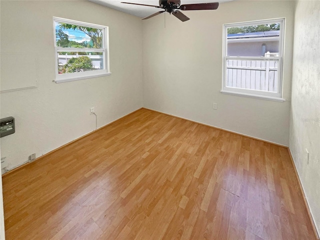 spare room with ceiling fan and light hardwood / wood-style flooring