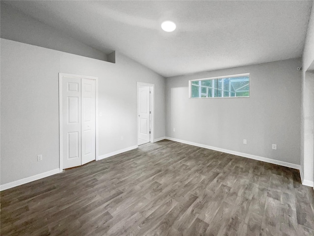 interior space featuring dark hardwood / wood-style floors and vaulted ceiling