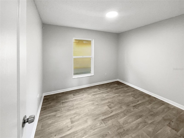 empty room with hardwood / wood-style flooring