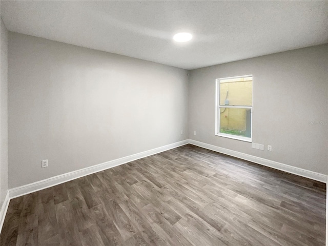 unfurnished room featuring dark hardwood / wood-style floors