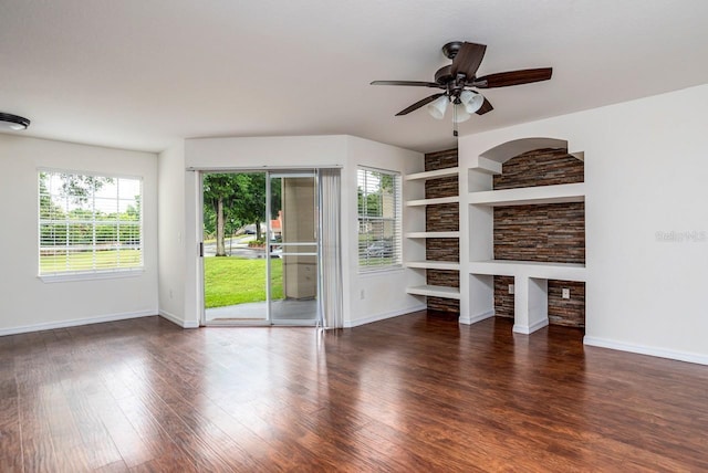 unfurnished living room with ceiling fan, a healthy amount of sunlight, dark hardwood / wood-style floors, and built in features