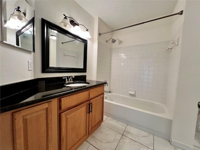 bathroom featuring vanity and tiled shower / bath combo