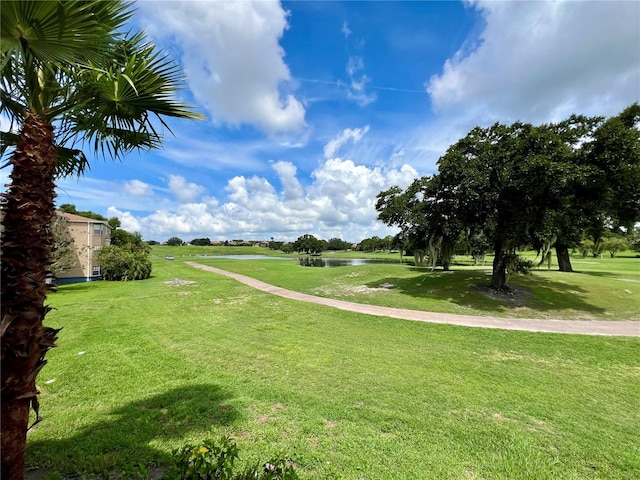 surrounding community with a yard and a water view