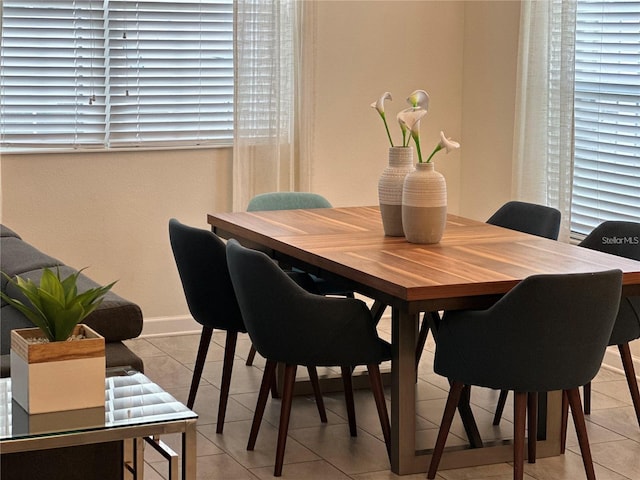 dining area featuring baseboards and light tile patterned flooring