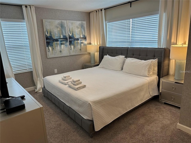 bedroom featuring dark colored carpet