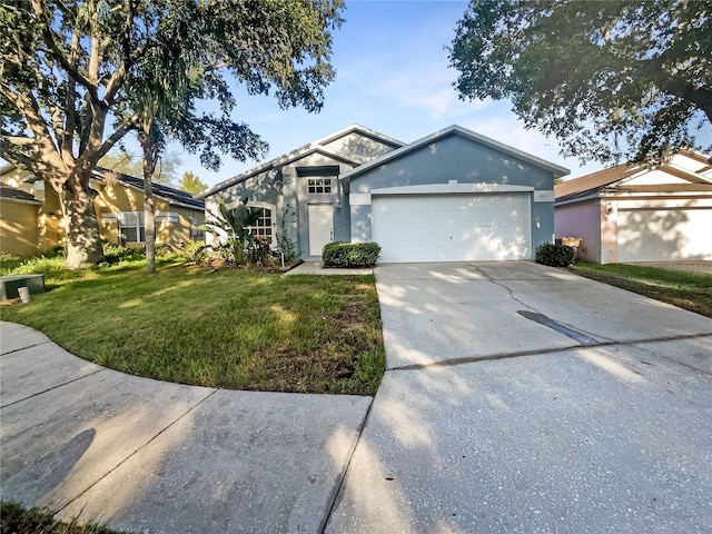 view of front of property featuring a garage and a front lawn