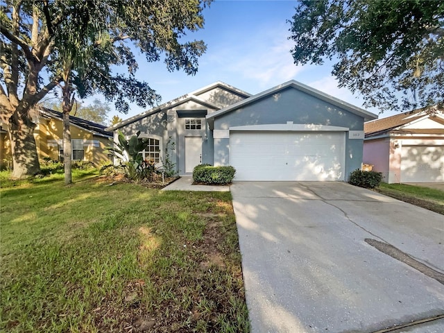 ranch-style house featuring a garage and a front lawn