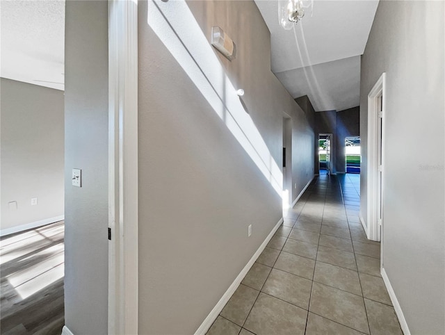 hall with light tile patterned floors