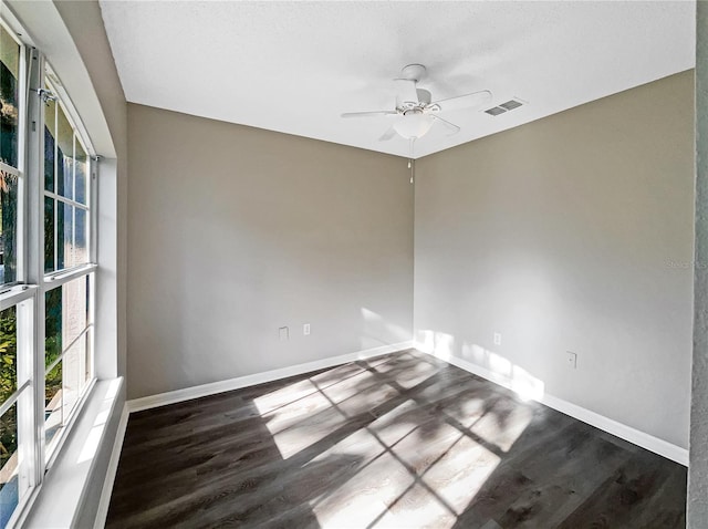 spare room featuring ceiling fan and dark hardwood / wood-style floors