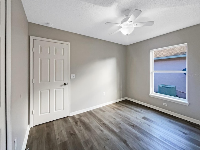 spare room featuring a textured ceiling, ceiling fan, and dark hardwood / wood-style floors