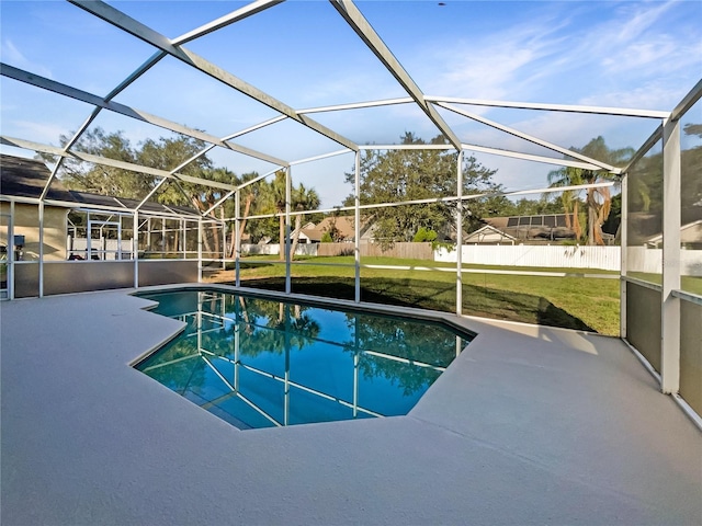 view of swimming pool featuring a lanai, a yard, and a patio