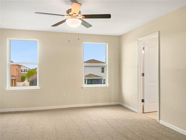 carpeted spare room with ceiling fan