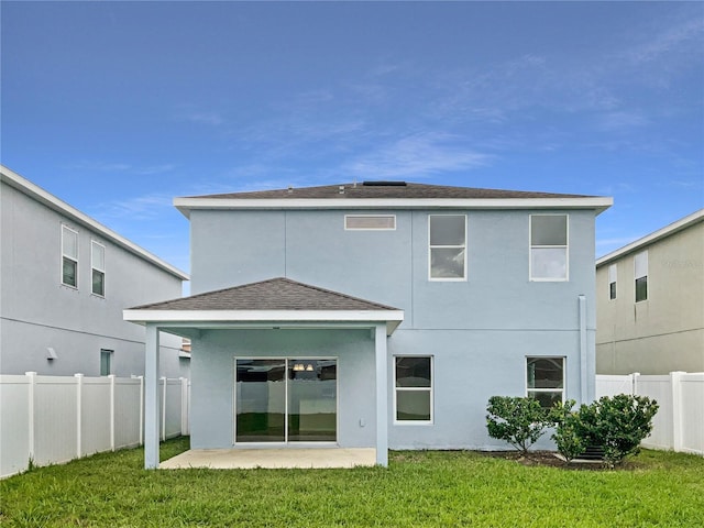 back of property featuring a patio area and a lawn