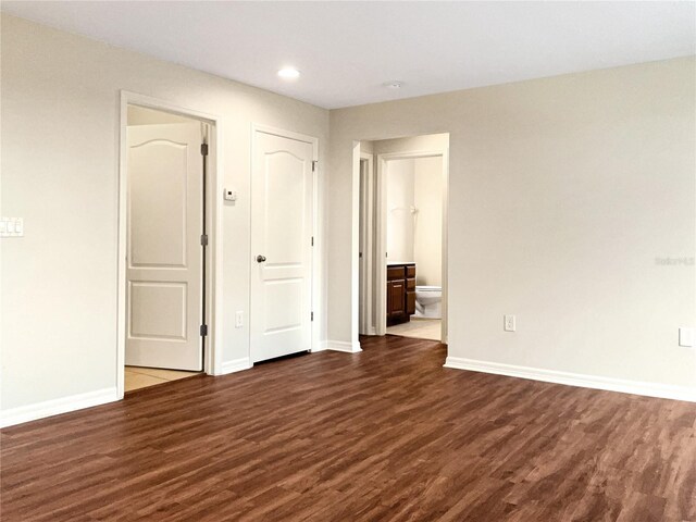 spare room with dark wood-type flooring