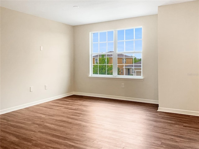 spare room with dark wood-type flooring