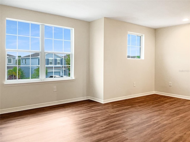 unfurnished room featuring hardwood / wood-style flooring