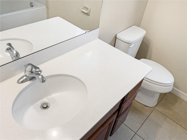 bathroom with tile patterned floors, vanity, and toilet