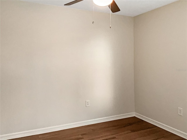 spare room with dark hardwood / wood-style floors and ceiling fan