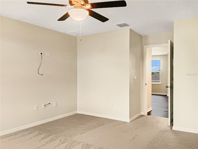 spare room featuring carpet and ceiling fan