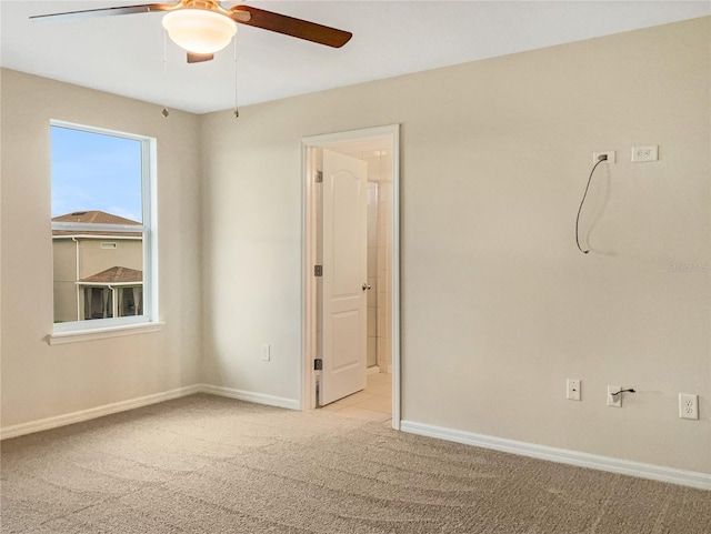 carpeted empty room with ceiling fan