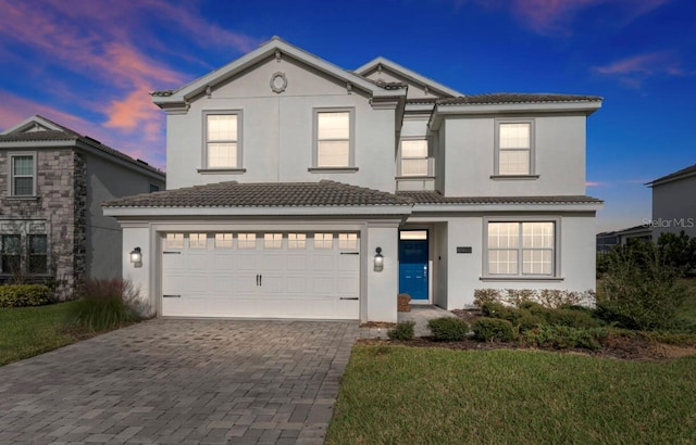 front of property featuring a garage and a yard