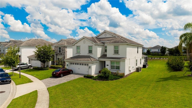 view of front of property with central AC, a garage, and a front yard